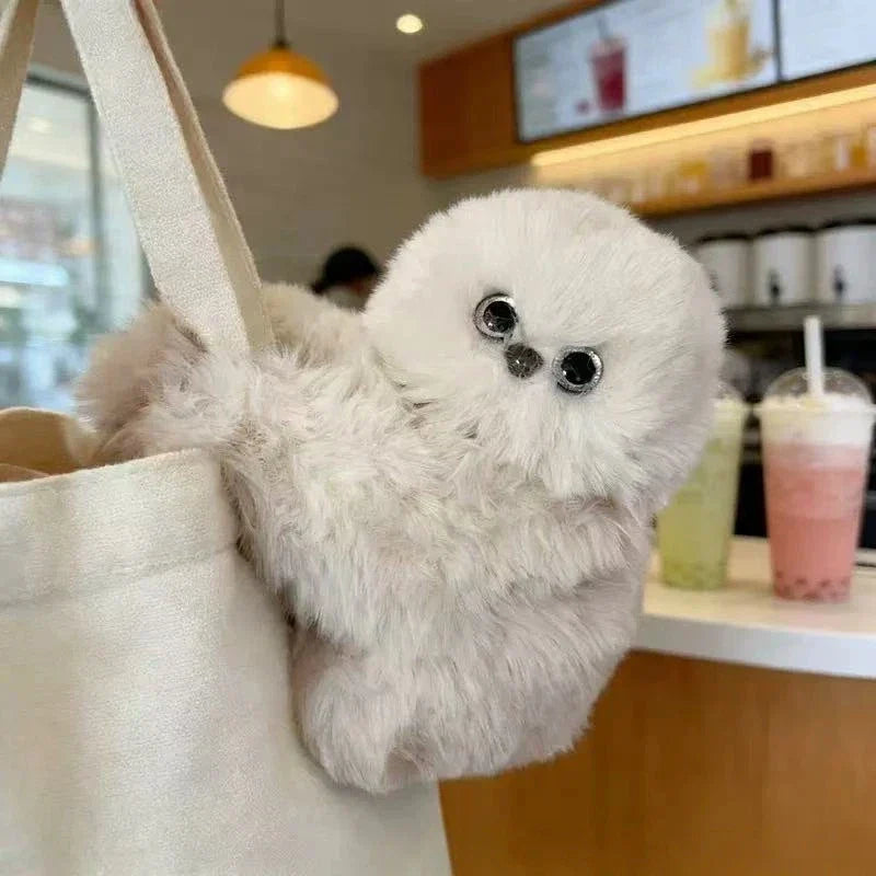 Solis Mirumi Bag Charm — clipped to a canvas tote in a cafe